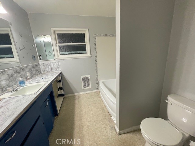 172 North 13th Street Grover Beach, CA 93433 - Photo 16 of 21 a bathroom with a granite countertop sink mirror vanity and toilet