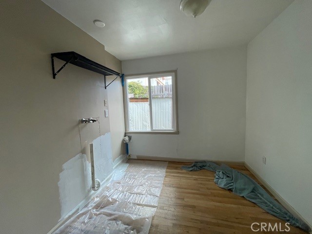 172 North 13th Street Grover Beach, CA 93433 - Photo 20 of 21 an empty room with wooden floor and windows