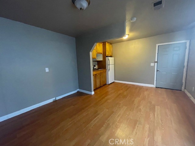 172 North 13th Street Grover Beach, CA 93433 - Photo 8 of 21 a view of empty room with wooden floor and windows