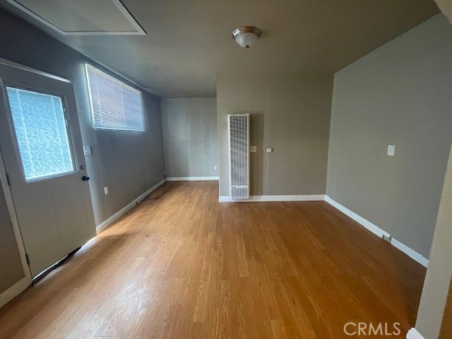 172 North 13th Street Grover Beach, CA 93433 - Photo 9 of 21 an empty room with wooden floor and windows