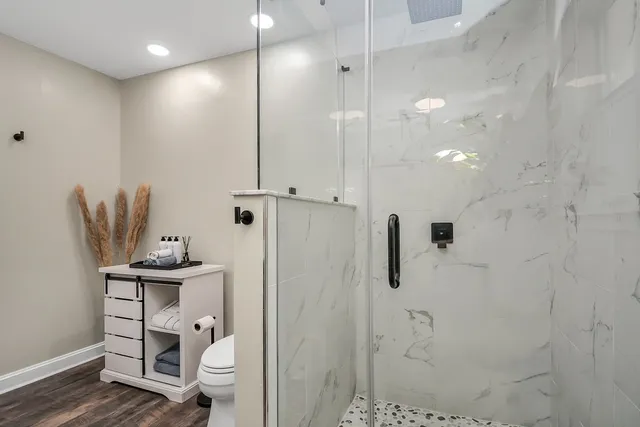 a patio with table and chairs and potted plants