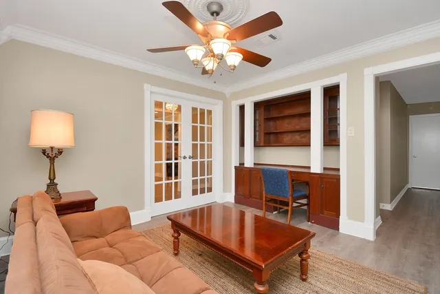 a dining room with furniture a chandelier and window