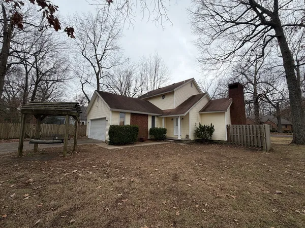 a view of a house with a yard covered in snow