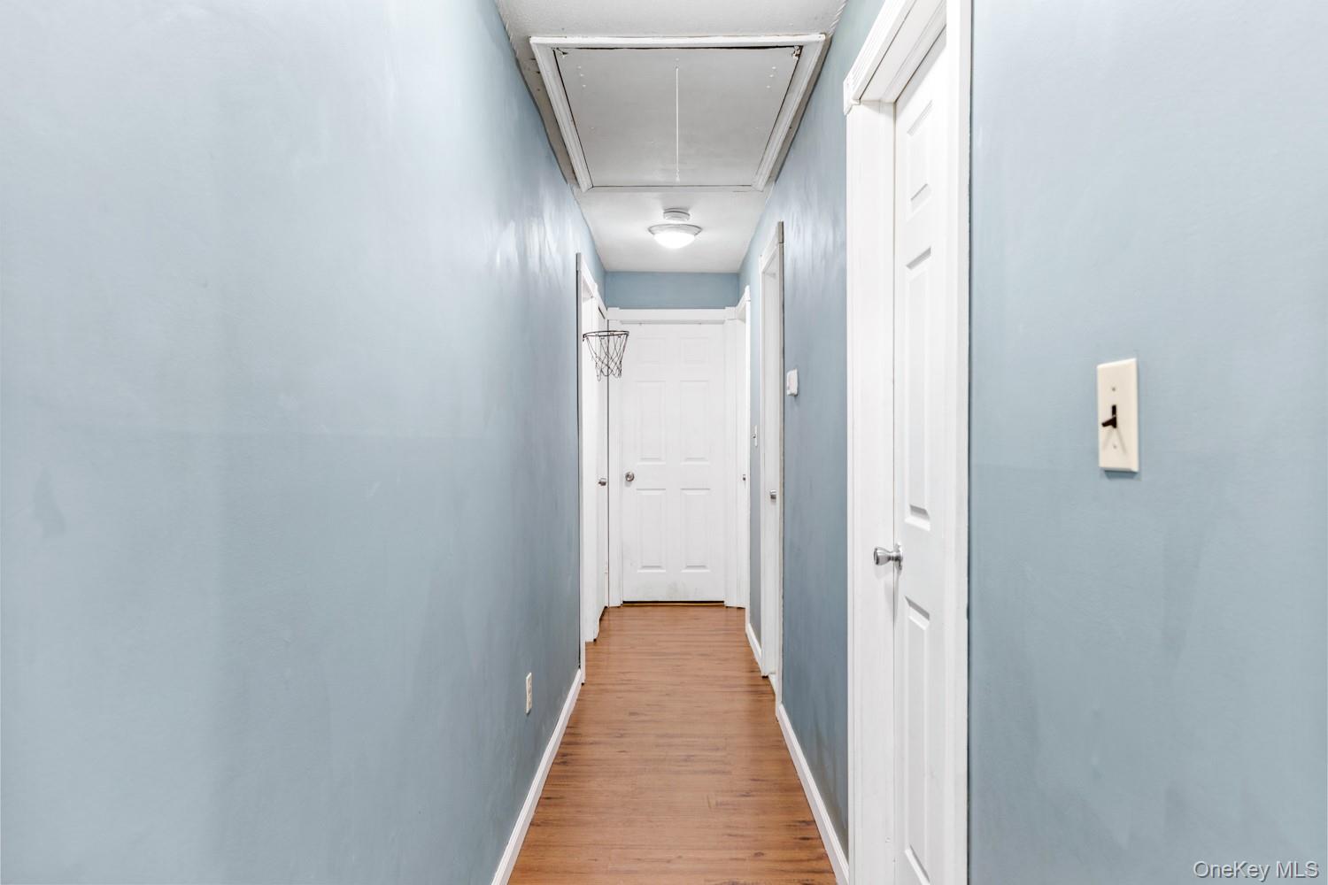 14 Comus Road Rocky Point, NY 11778 - Photo 12 of 23 a view of a hallway with wooden floor