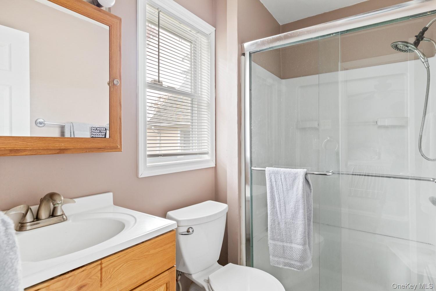 14 Comus Road Rocky Point, NY 11778 - Photo 18 of 23 a white toilet sitting next to a bathroom sink