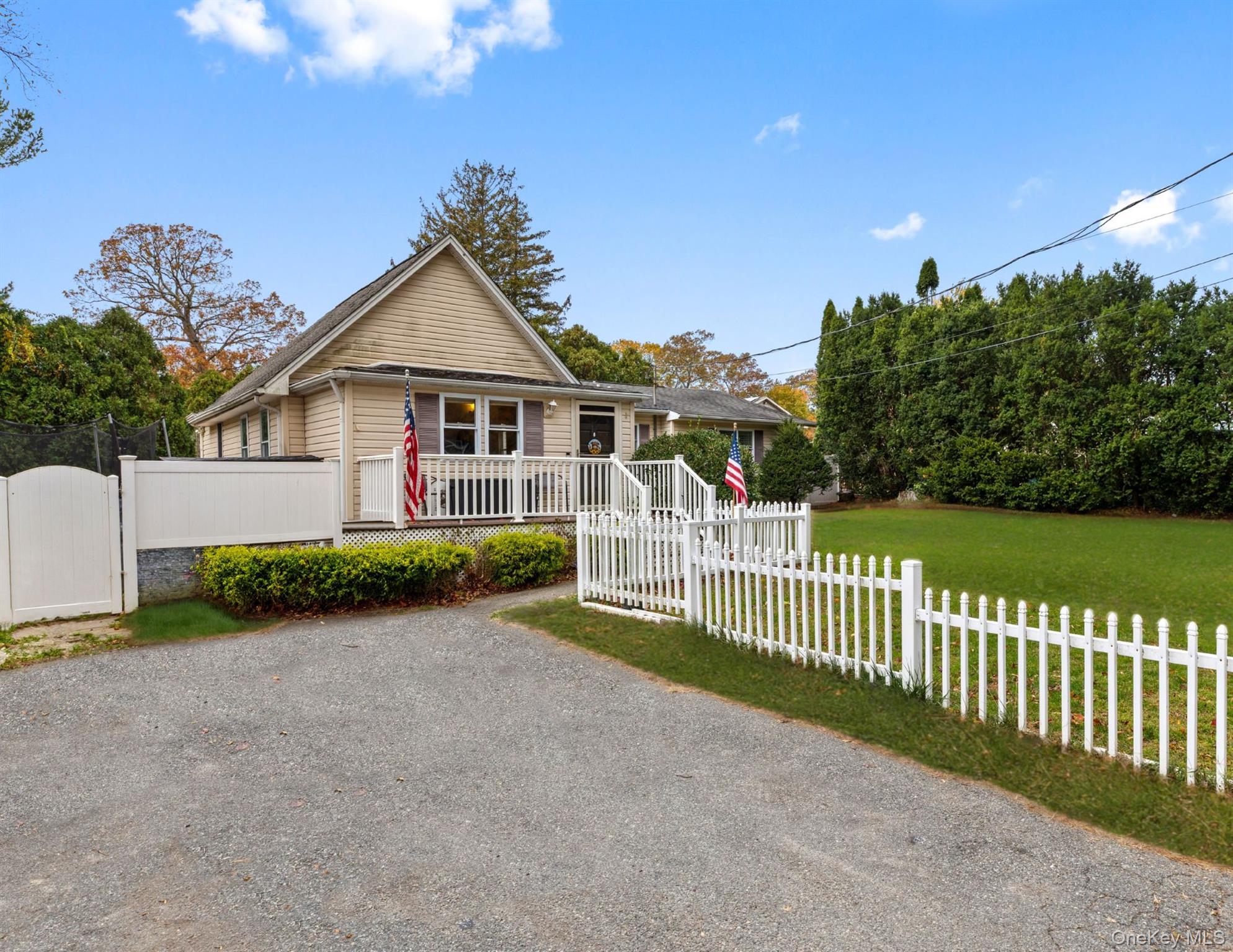 14 Comus Road Rocky Point, NY 11778 - Photo 2 of 23 a view of a house with wooden fence next to a yard