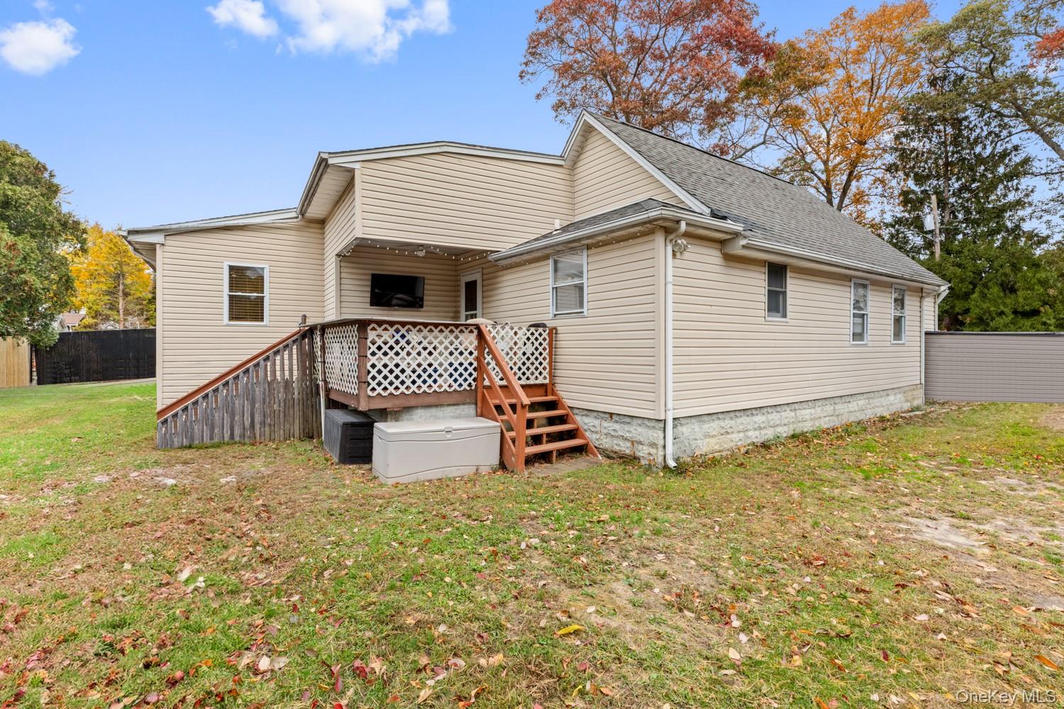 14 Comus Road Rocky Point, NY 11778 - Photo 23 of 23 a white house that has a small yard and large trees
