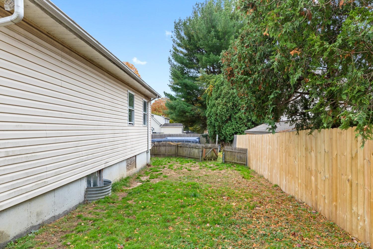 14 Comus Road Rocky Point, NY 11778 - Photo 4 of 23 a view of a backyard with a small cabin
