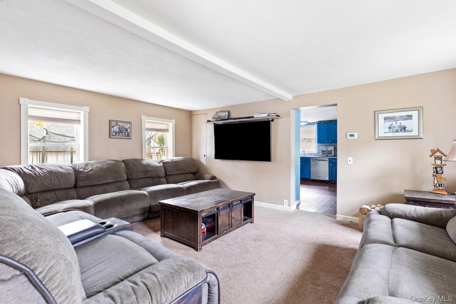14 Comus Road Rocky Point, NY 11778 - Photo 5 of 23 a living room with furniture and a flat screen tv