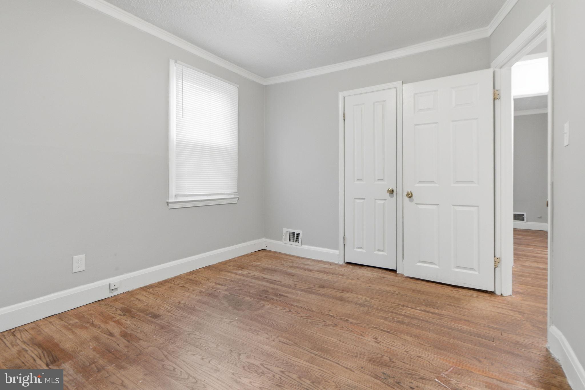 5330 Dogwood Road Woodlawn, MD 21207 - Photo 12 of 38 a view of an empty room with wooden floor and a window