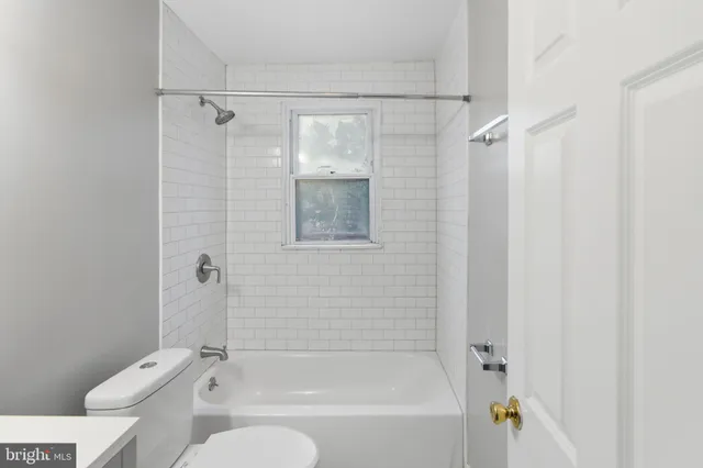 a bathroom with a shower a toilet and a shower