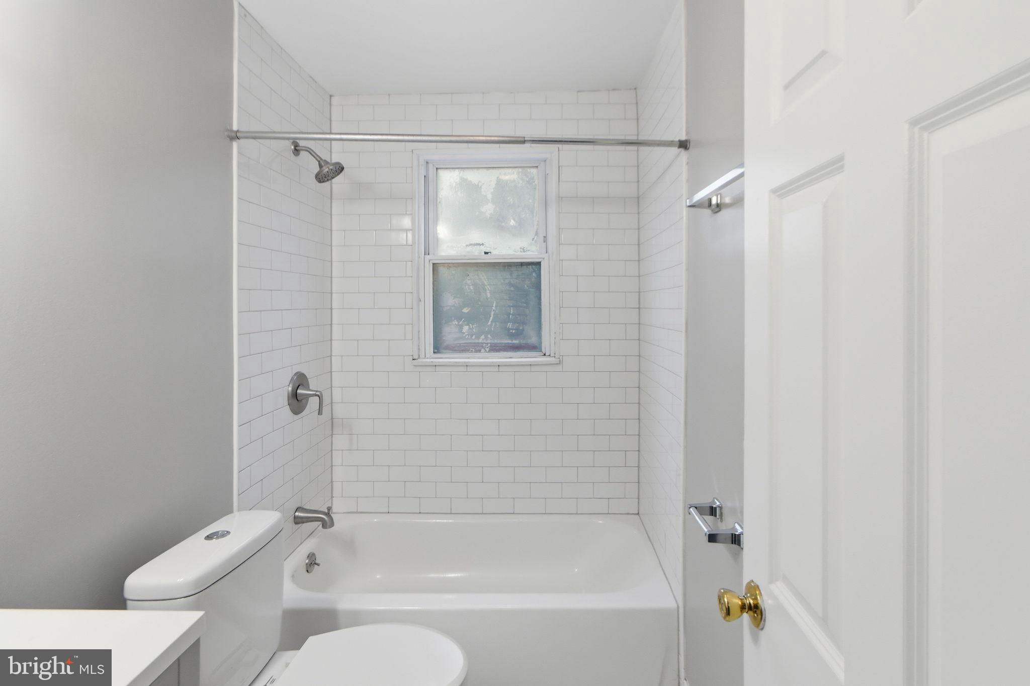 5330 Dogwood Road Woodlawn, MD 21207 - Photo 15 of 38 a bathroom with a shower a toilet and a shower