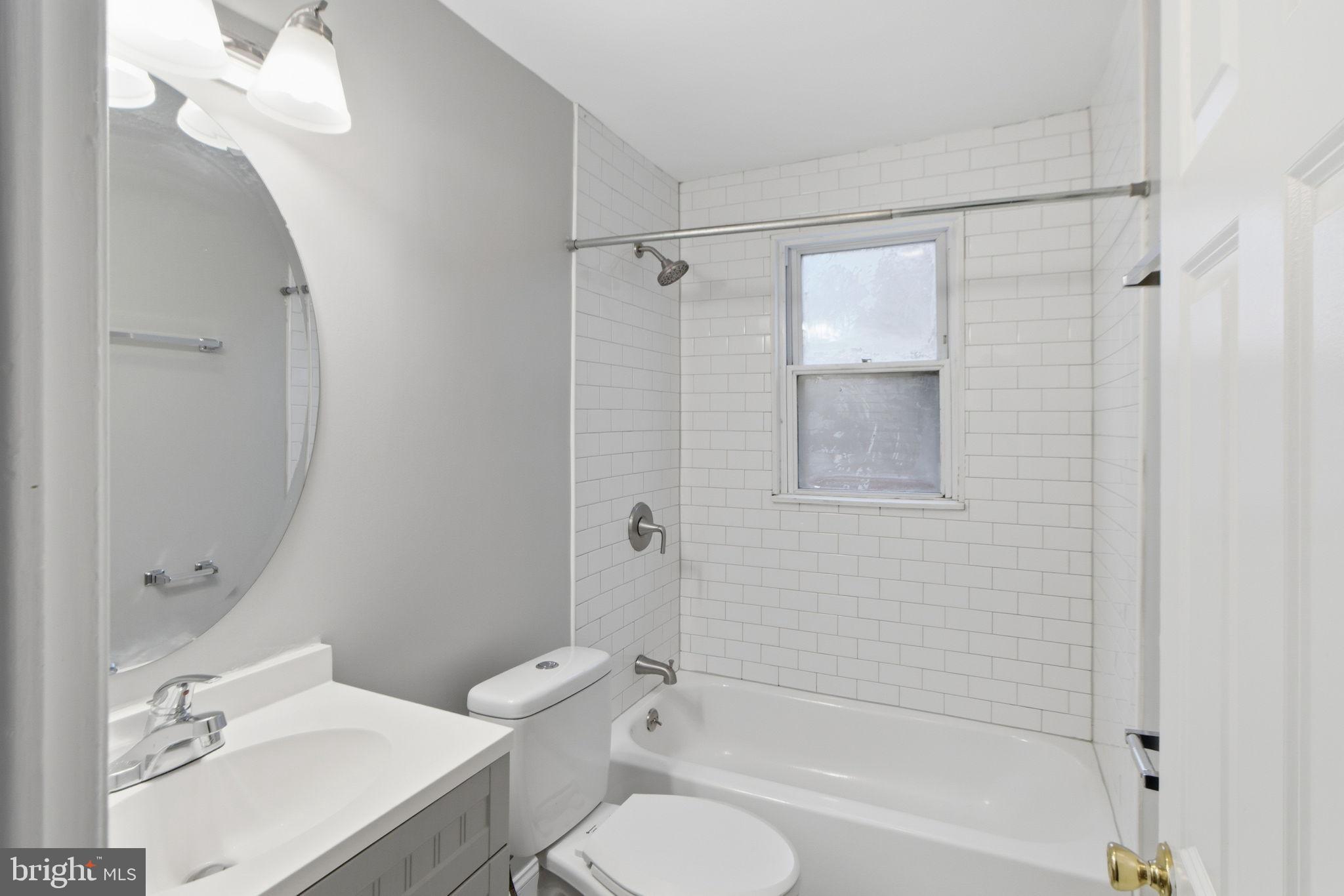 5330 Dogwood Road Woodlawn, MD 21207 - Photo 16 of 38 a bathroom with a sink toilet and shower