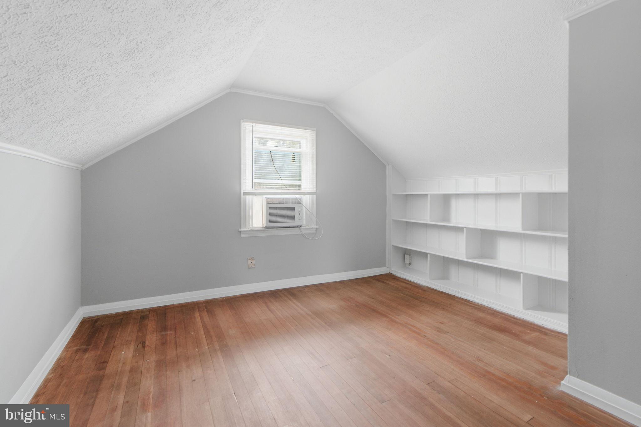 5330 Dogwood Road Woodlawn, MD 21207 - Photo 18 of 38 a view of an empty room with a window and wooden floor
