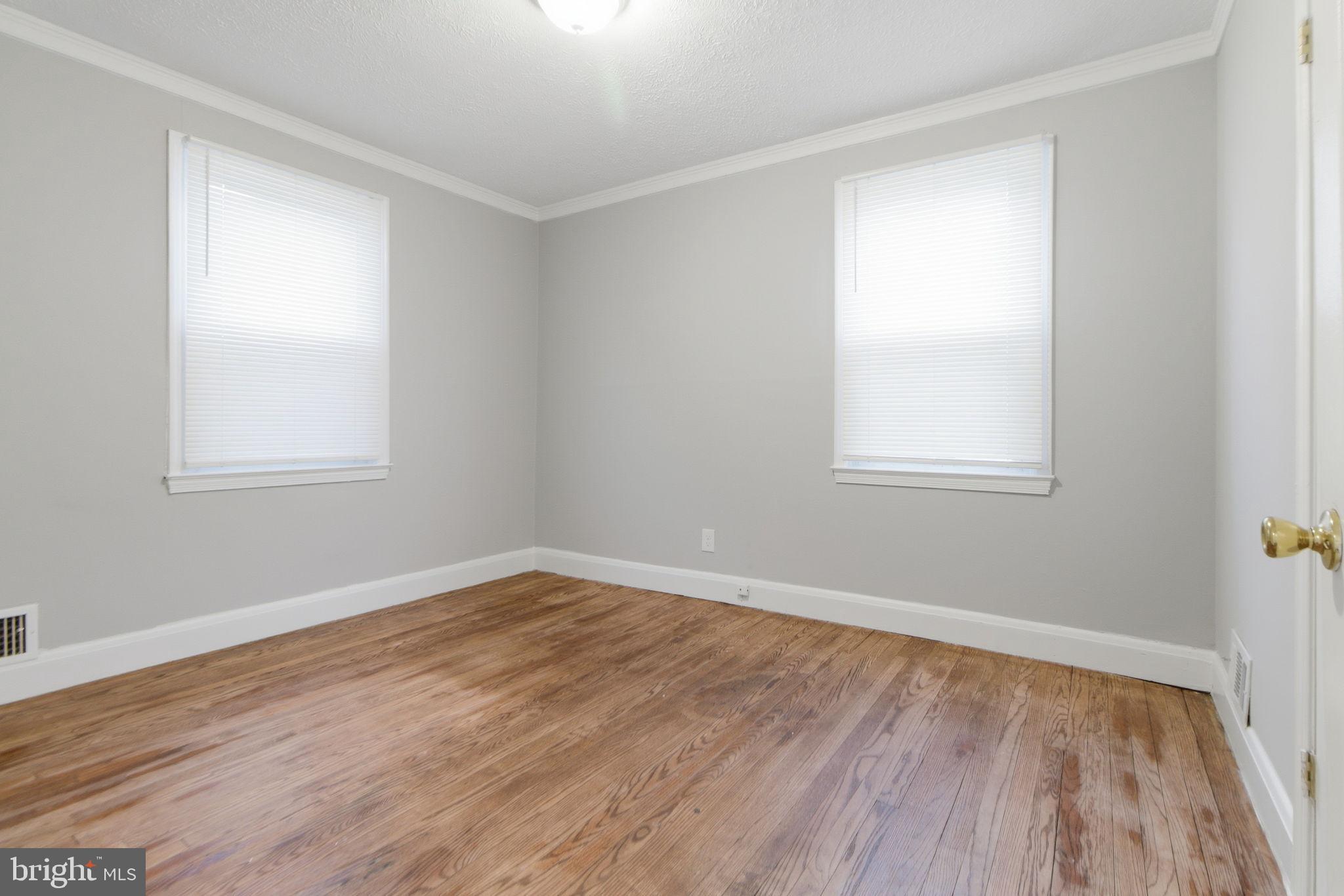 5330 Dogwood Road Woodlawn, MD 21207 - Photo 19 of 38 an empty room with wooden floor and windows