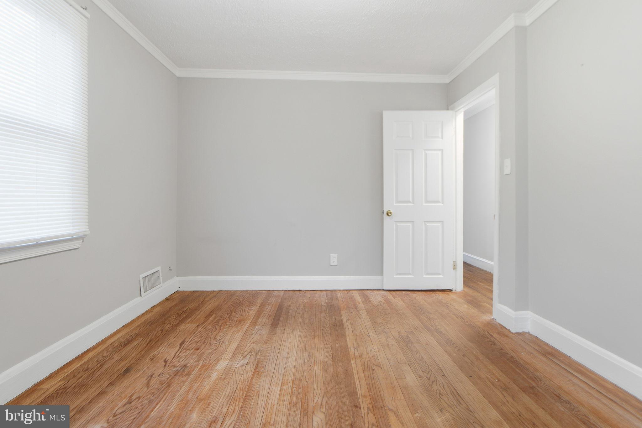 5330 Dogwood Road Woodlawn, MD 21207 - Photo 20 of 38 a view of a room with wooden floor and white walls