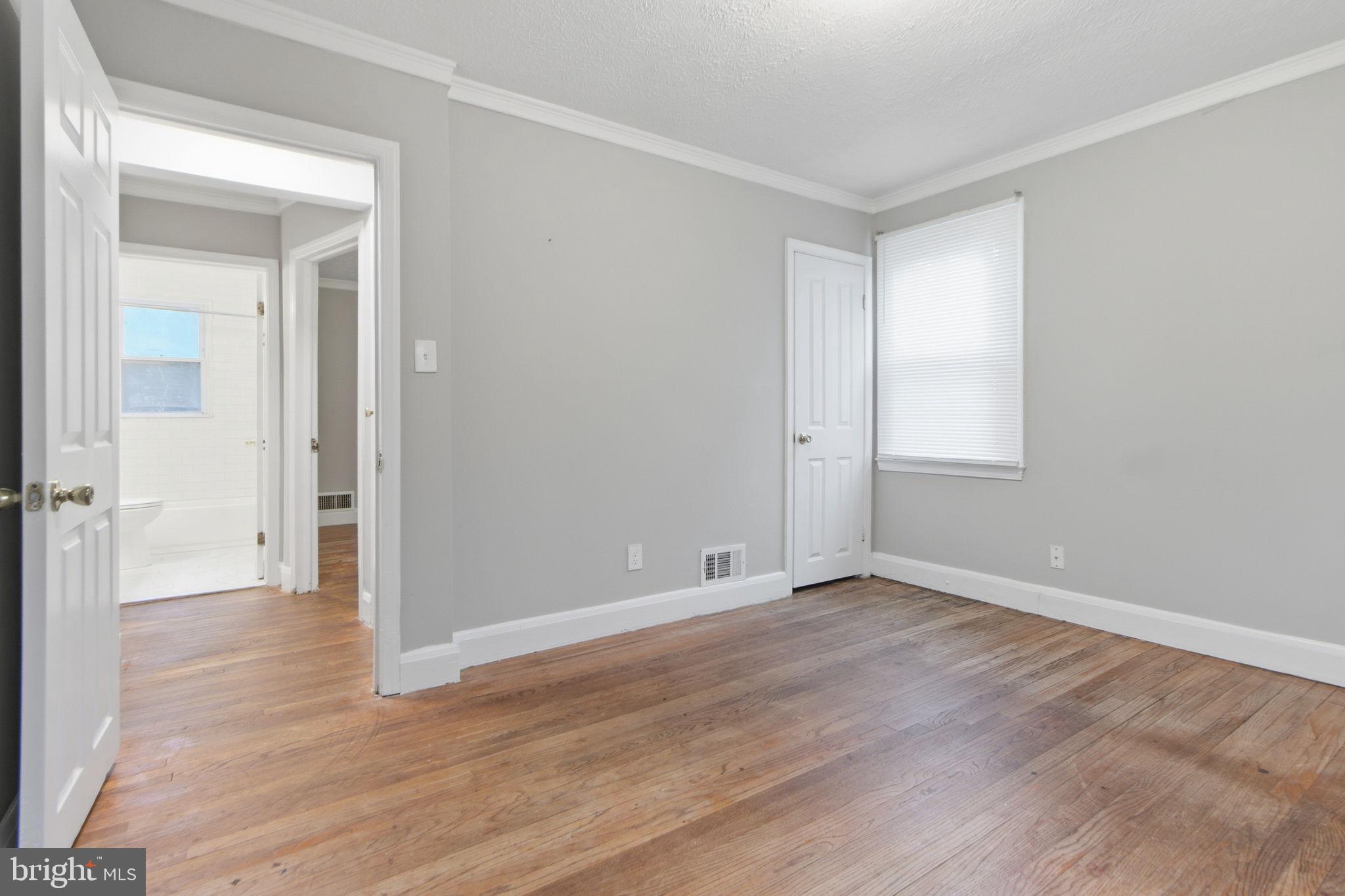 5330 Dogwood Road Woodlawn, MD 21207 - Photo 22 of 38 a view of an empty room with wooden floor and closet