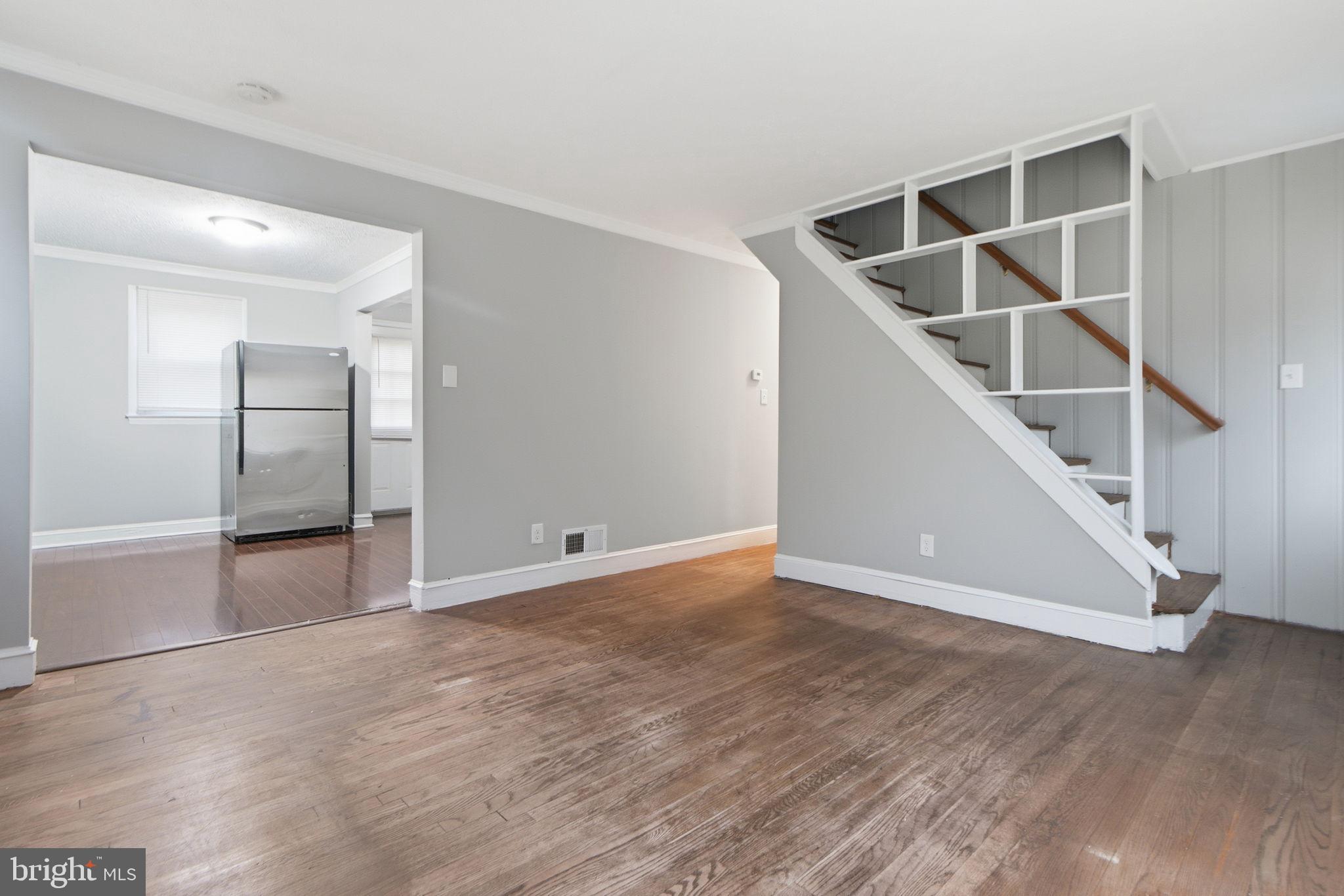 5330 Dogwood Road Woodlawn, MD 21207 - Photo 3 of 38 an empty room with wooden floor and staircase