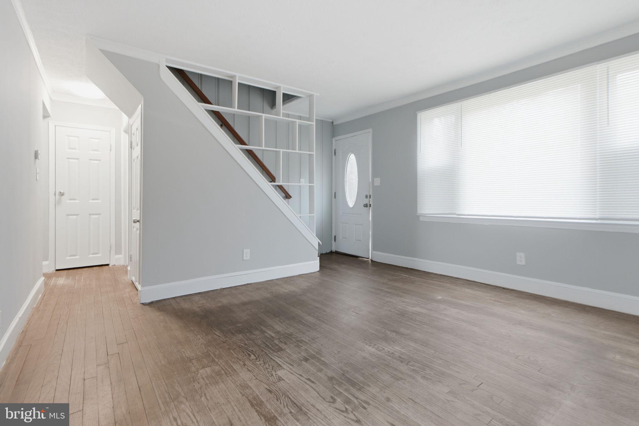 5330 Dogwood Road Woodlawn, MD 21207 - Photo 4 of 38 an empty room with wooden floor and windows
