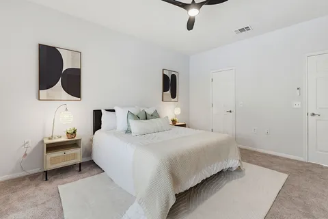 a spacious bedroom with a bed and a window