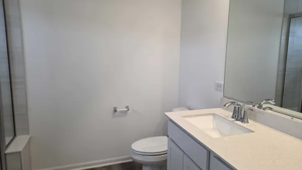 a bathroom with a sink toilet and a mirror