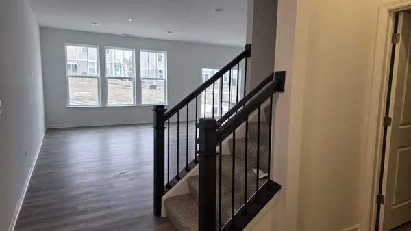 a view of an entryway with wooden floor and door