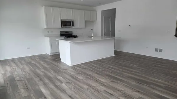 a kitchen with granite countertop a sink and a stove top oven