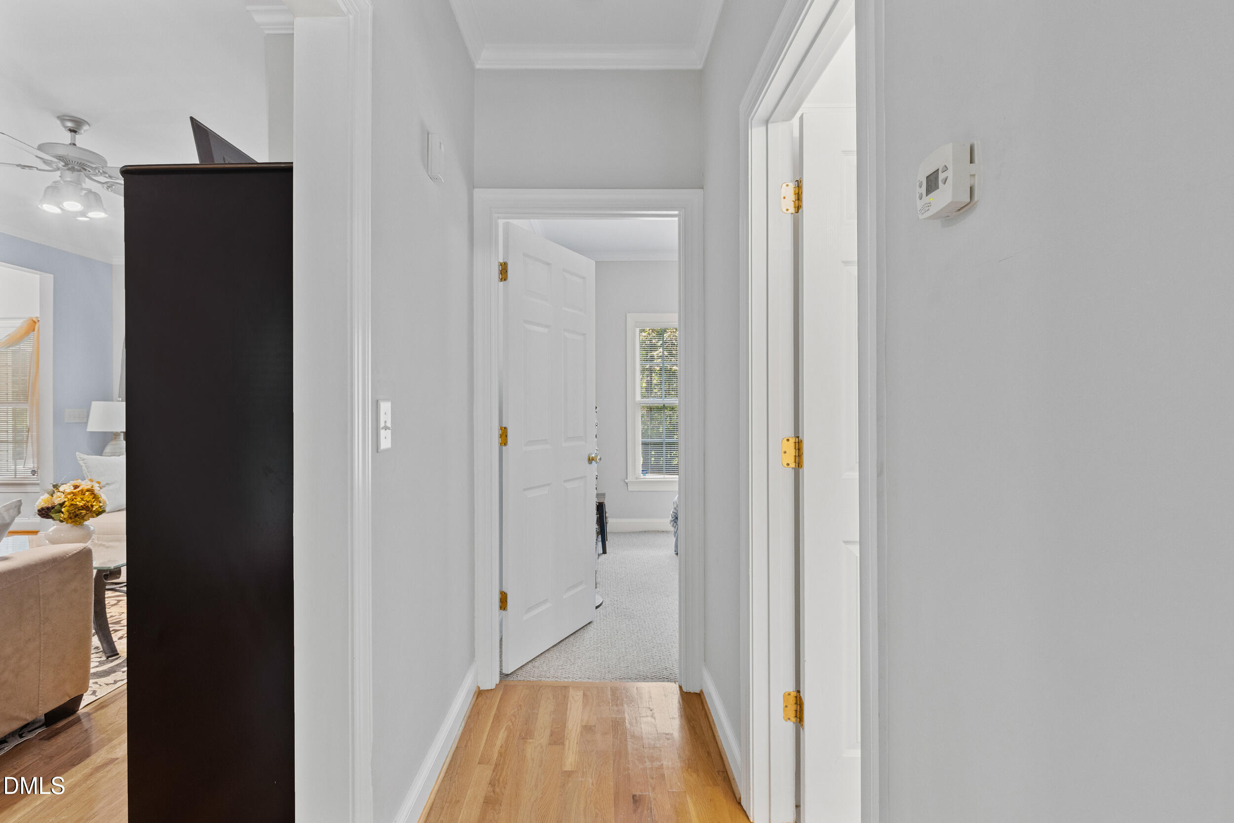 7619 Whitaker Drive Summerfield, NC 27358 - Photo 12 of 25 a view of a hallway with wooden floor and a bathroom