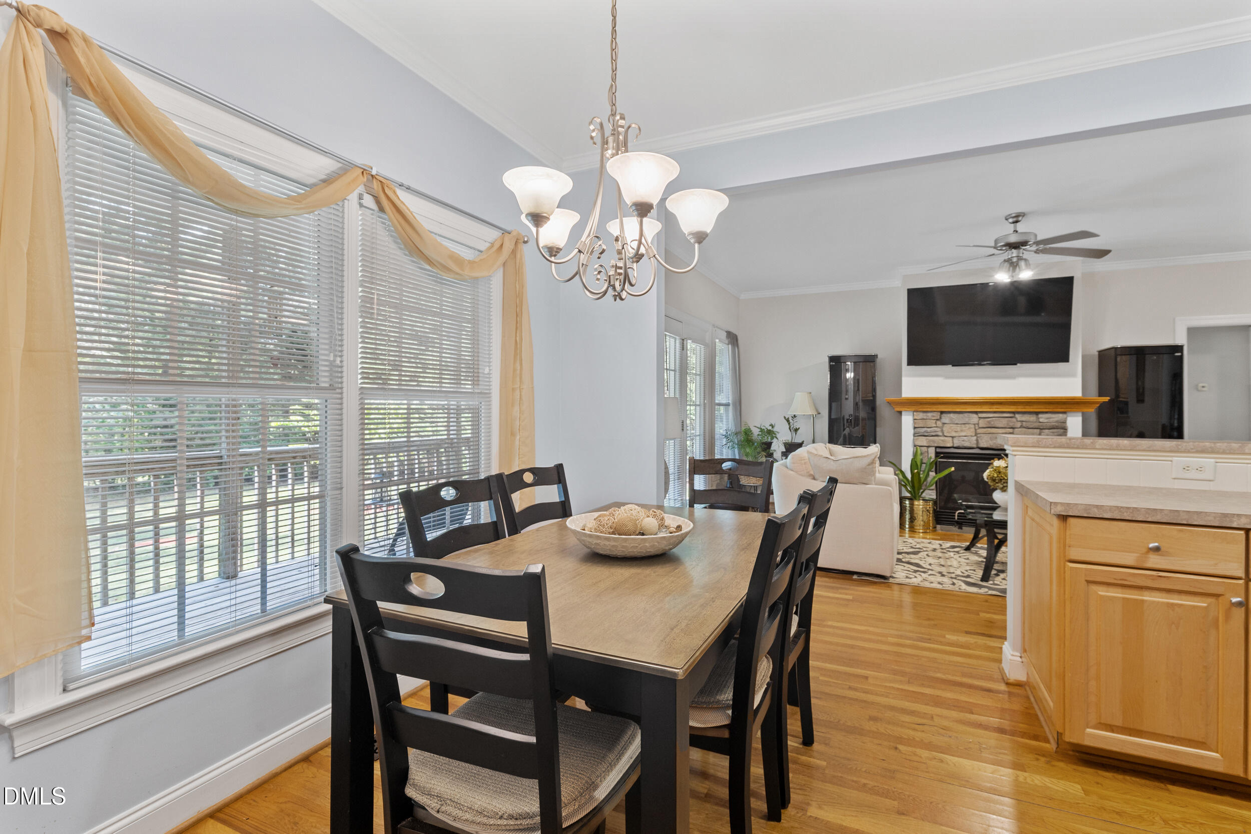 7619 Whitaker Drive Summerfield, NC 27358 - Photo 17 of 25 a view of a dining room with furniture a chandelier and wooden floor