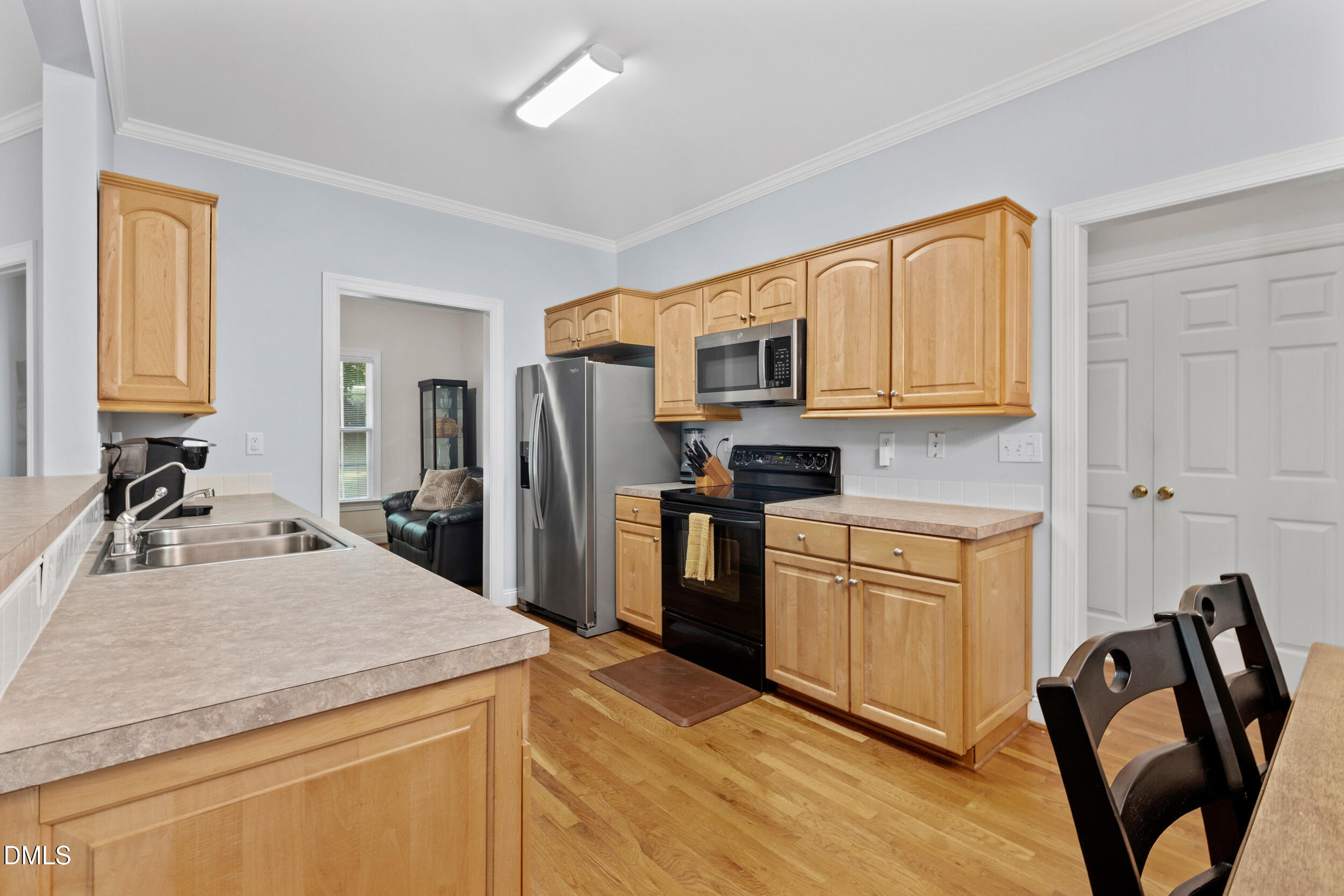 7619 Whitaker Drive Summerfield, NC 27358 - Photo 18 of 25 a kitchen with stainless steel appliances granite countertop a sink stove and refrigerator