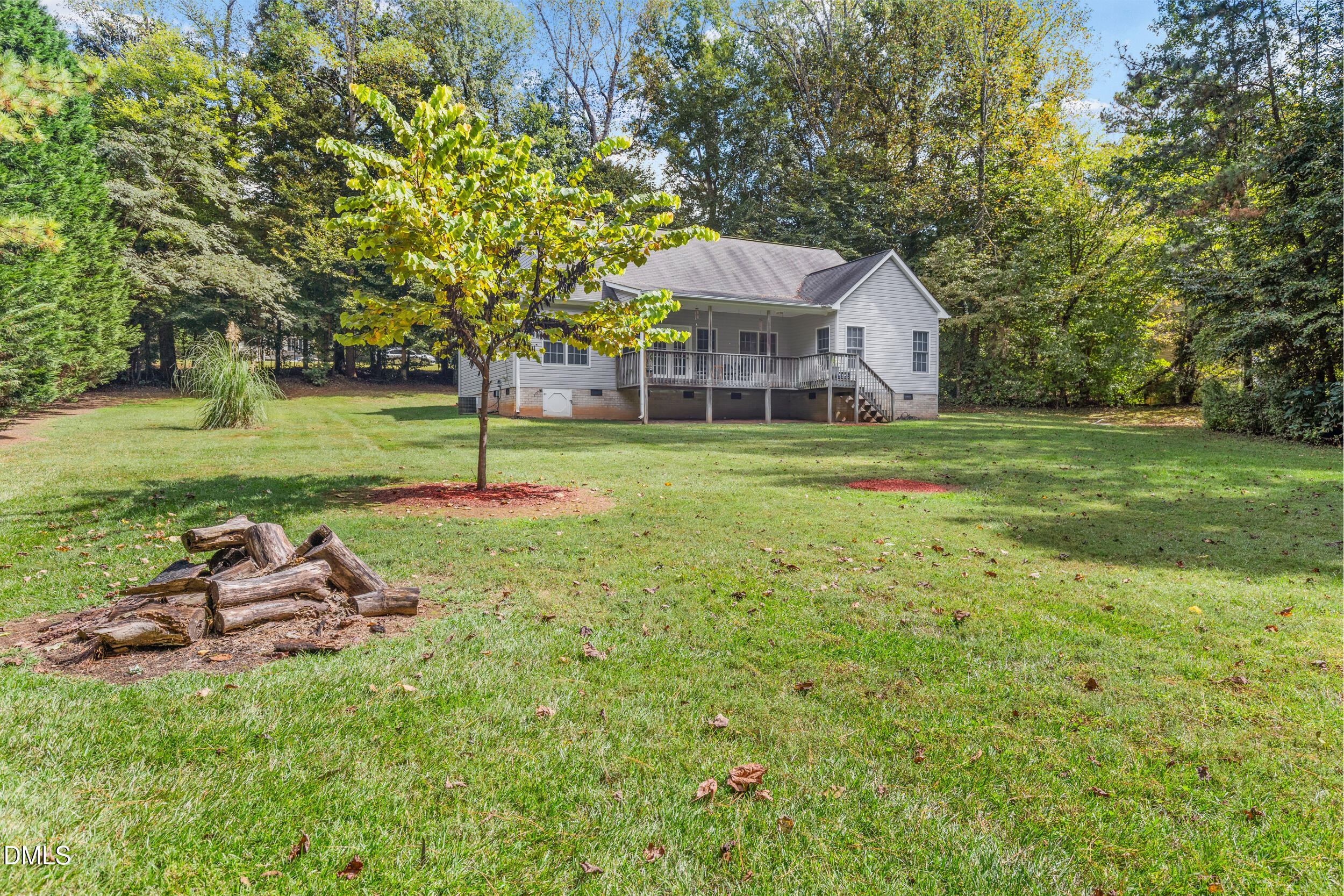 7619 Whitaker Drive Summerfield, NC 27358 - Photo 3 of 25 a yellow house in middle of the forest