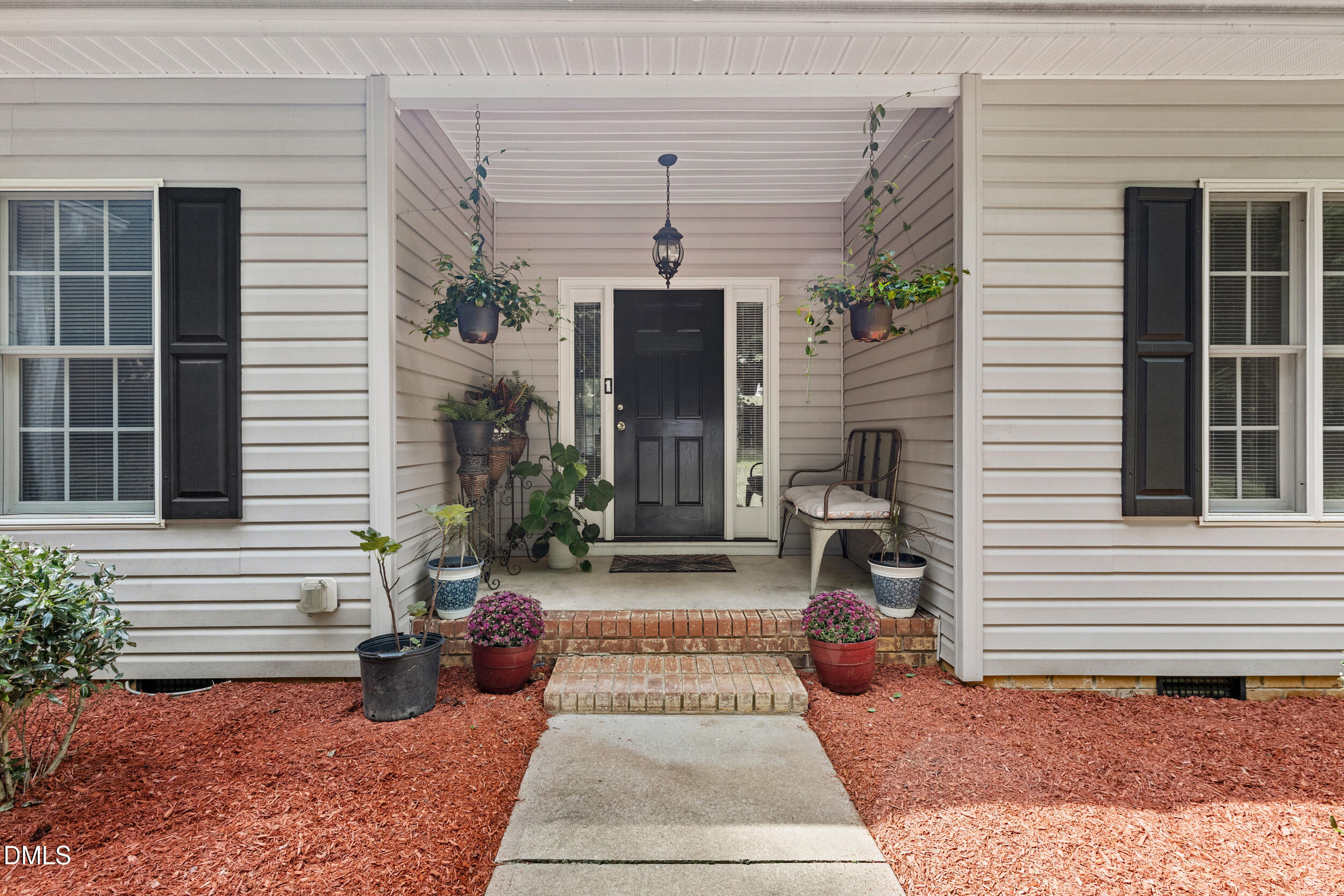 7619 Whitaker Drive Summerfield, NC 27358 - Photo 6 of 25 a view of a patio with two chairs and a potted plant