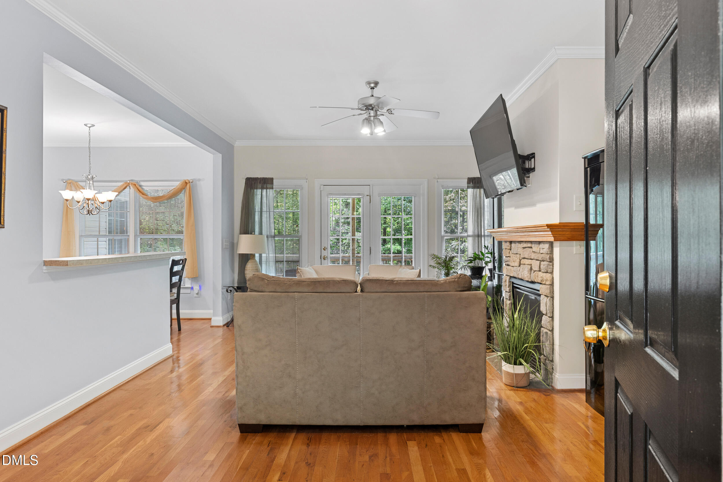 7619 Whitaker Drive Summerfield, NC 27358 - Photo 7 of 25 a living room with furniture and a chandelier