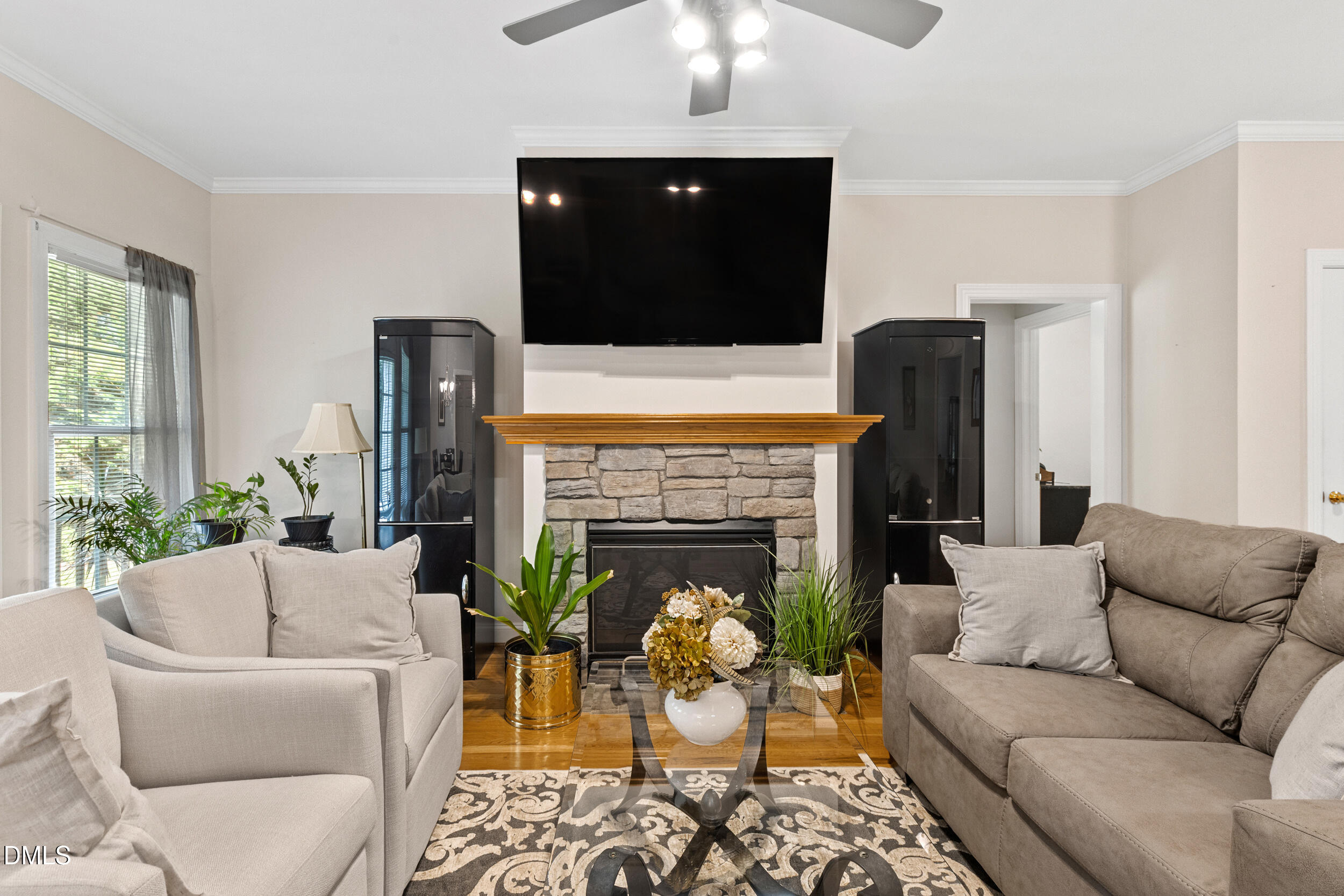 7619 Whitaker Drive Summerfield, NC 27358 - Photo 9 of 25 a living room with furniture a fireplace and a flat screen tv