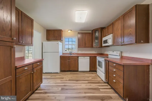 a kitchen with stainless steel appliances granite countertop a stove a sink dishwasher and a refrigerator
