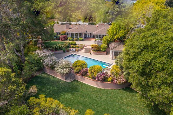 a view of a house with a yard and garden