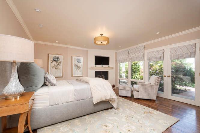 840 Longview Road Hillsborough, CA 94010 - Photo 14 of 49 a bedroom with a large bed and a tv