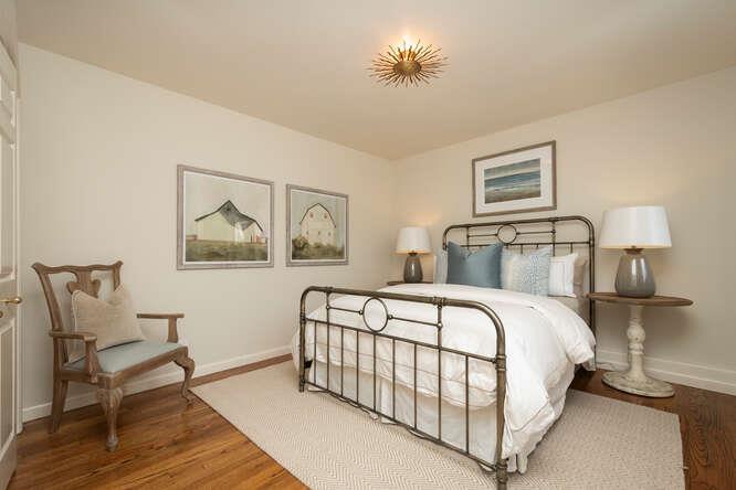 840 Longview Road Hillsborough, CA 94010 - Photo 25 of 49 a bedroom with a bed and a chandelier