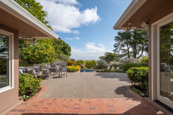 840 Longview Road Hillsborough, CA 94010 - Photo 8 of 49 a view of a patio with table and chairs and potted plants