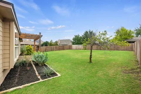 a view of a garden with a house