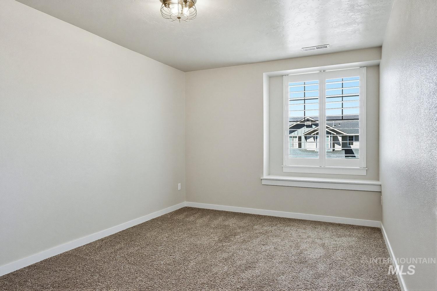 846 North Hidden View Way Star, ID 83669 - Photo 40 of 49 Room featuring neutral-toned walls, plush carpet flooring, and a window with white plantation shutters