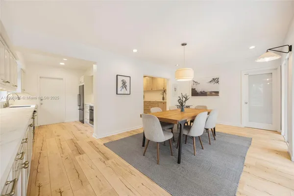 a view of a dining room with furniture and wooden floor