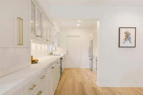 a bathroom with a sink a mirror and a shower
