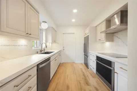 a kitchen with a sink stove and cabinets