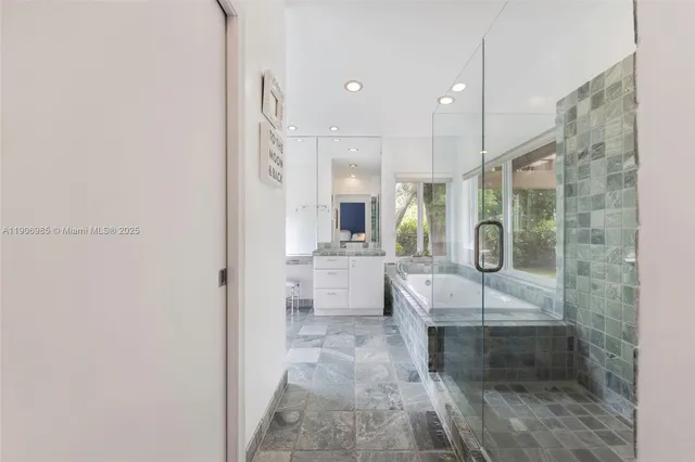 a large bathroom with a tub shower and sink