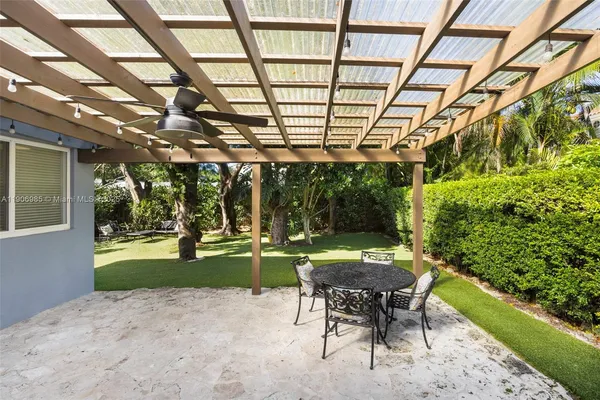 a patio with yard and outdoor seating