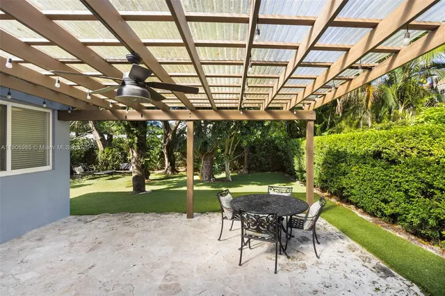 a patio with yard and outdoor seating