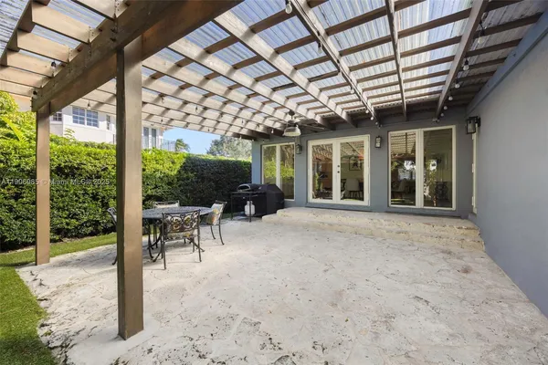 a view of a porch with furniture and a yard