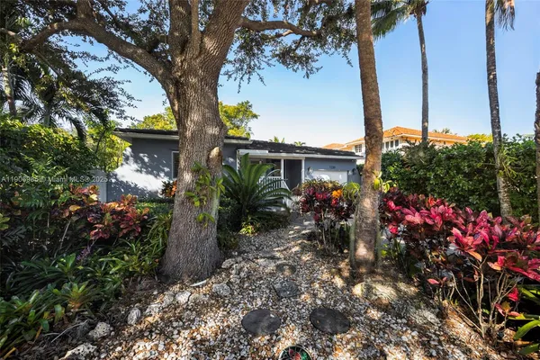 a view of a house with a flower garden