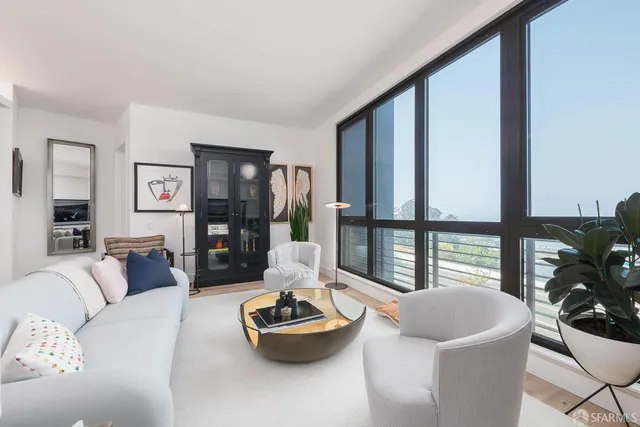 a living room with furniture and a floor to ceiling window